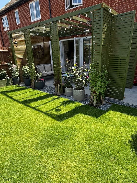 Garden pergola with slatted screens, a new lawn and patio seating